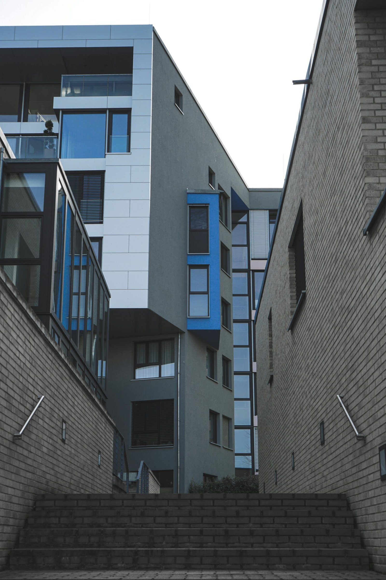 gray concrete building with blue windows